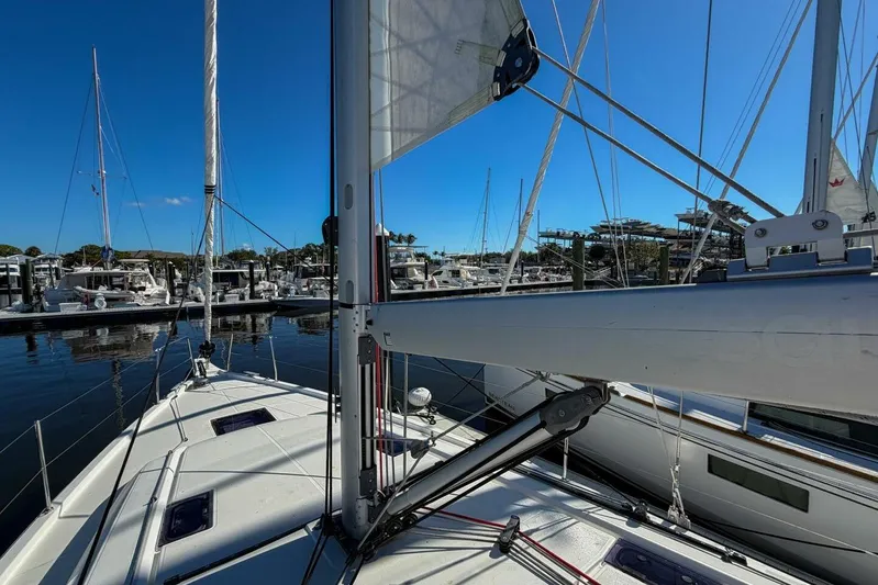 Happy Ours Yacht Photos Pics 2022 Beneteau Oceanis 40.1 sailboat docked at marina under clear blue sky.