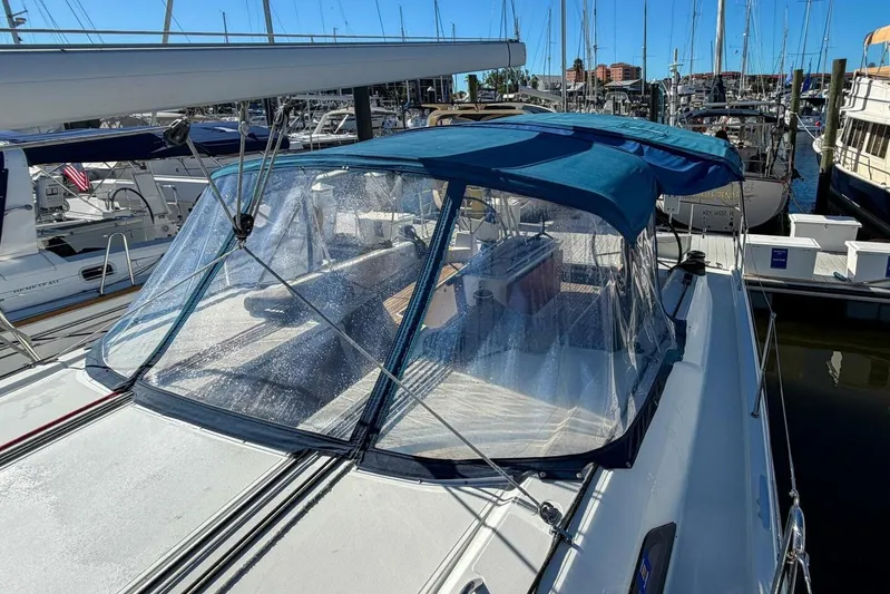 Happy Ours Yacht Photos Pics 2022 Beneteau Oceanis 40.1 sailboat with blue canopy docked at marina.