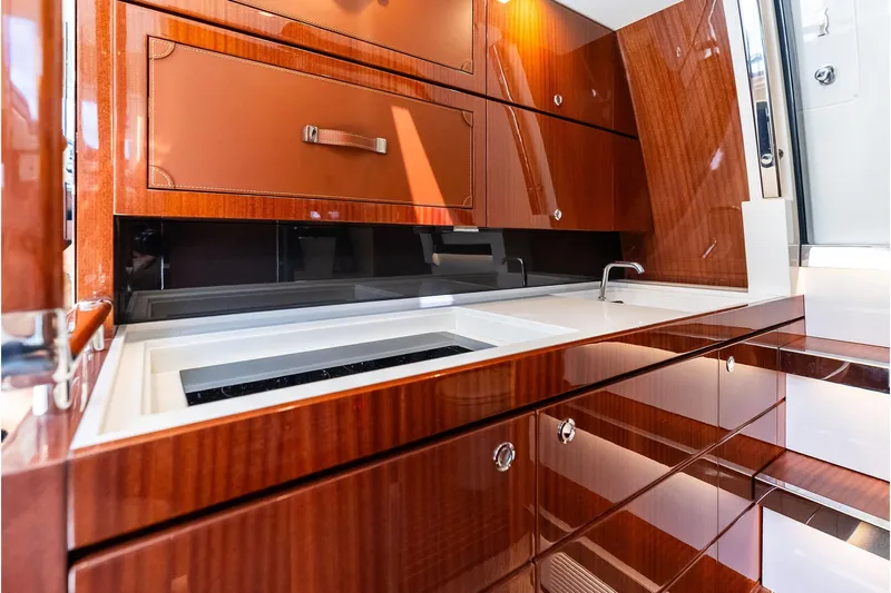 Grey Yacht Photos Pics Luxurious 2023 Riva Rivamare yacht interior with sleek wooden cabinetry and modern sink.