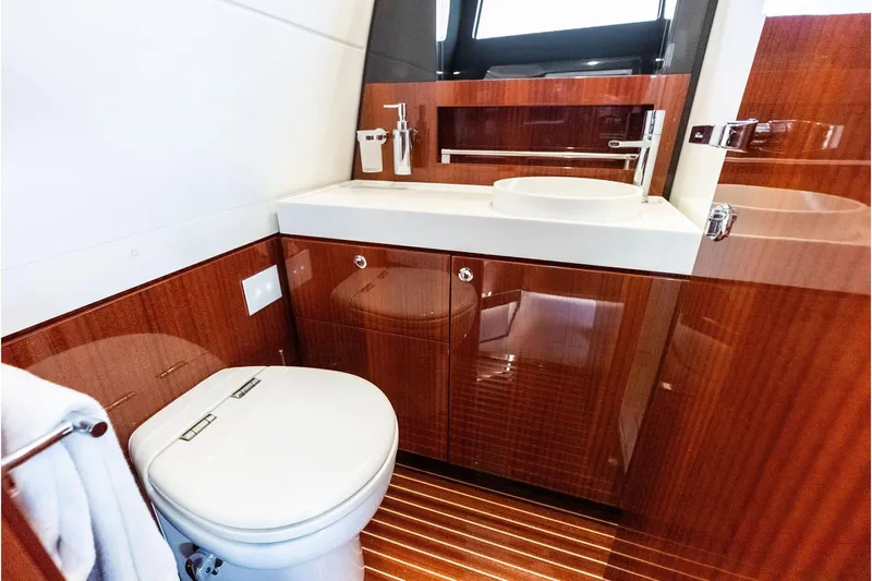 Grey Yacht Photos Pics Luxurious 2023 Riva Rivamare yacht bathroom with elegant wood finish and modern fixtures.