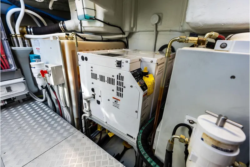 Grey Yacht Photos Pics Engine room of 2023 Riva Rivamare yacht, showcasing mechanical components and piping.