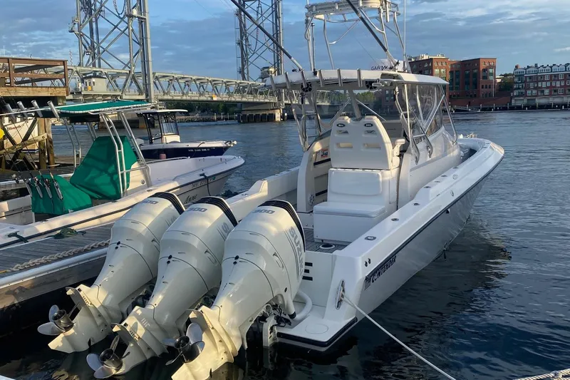 Blue Sky Yacht Photos Pics 2005 Contender 36 Fisharound boat docked with triple outboard engines.