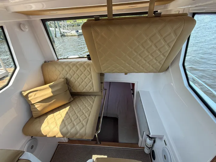 Willow Run Yacht Photos Pics Interior of 2021 Axopar 28 CABIN with beige quilted seating and water view.