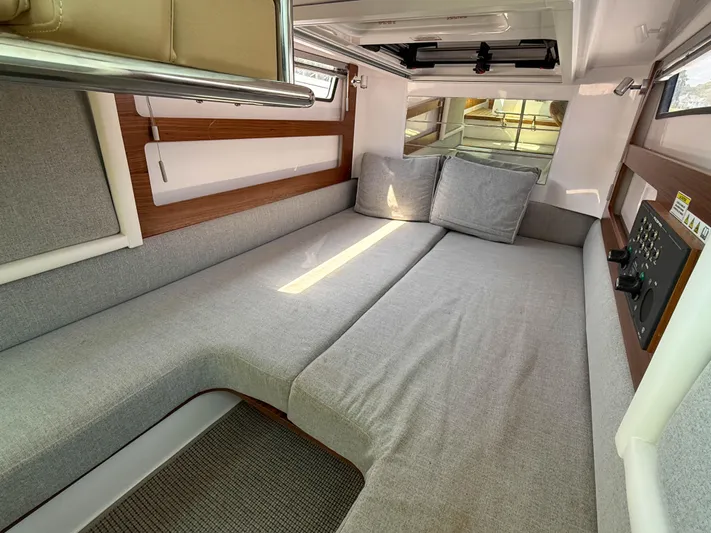Willow Run Yacht Photos Pics 2021 Axopar 28 CABIN interior with gray seating and wooden accents.