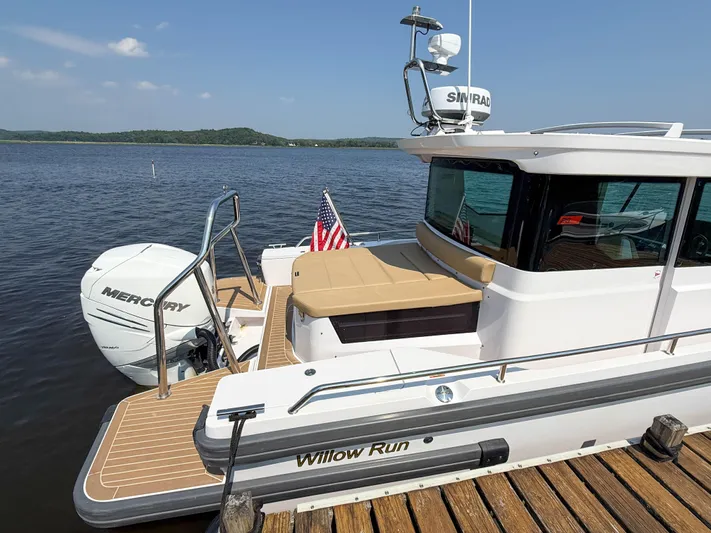 Willow Run Yacht Photos Pics 2021 Axopar 28 CABIN boat docked, featuring Mercury engine and American flag.