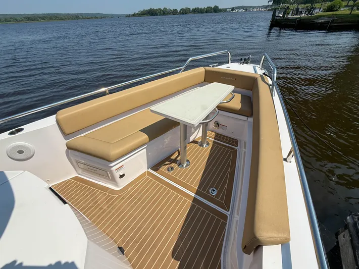 Willow Run Yacht Photos Pics Luxurious seating area on 2021 Axopar 28 CABIN boat with scenic water view.