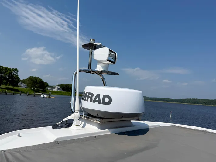Willow Run Yacht Photos Pics Axopar 28 CABIN 2021 boat with radar system on a sunny day by the water.
