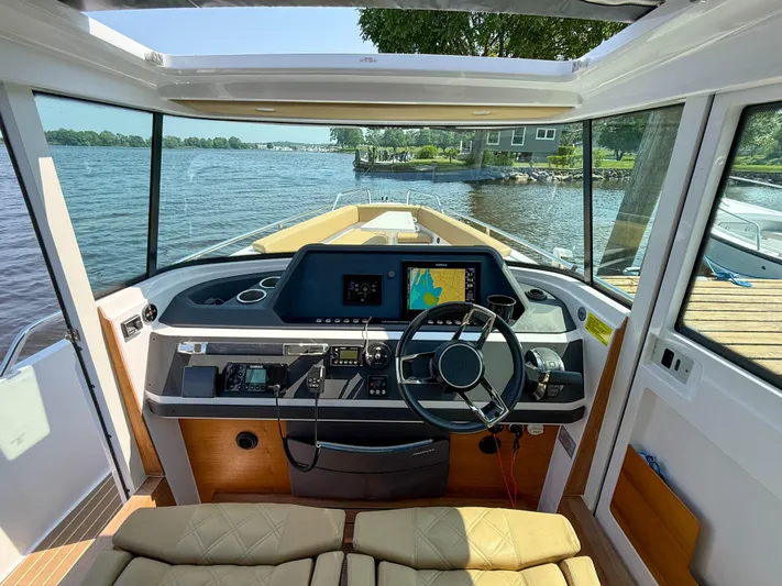 Willow Run Yacht Photos Pics 2021 Axopar 28 CABIN boat interior with steering wheel and navigation system.