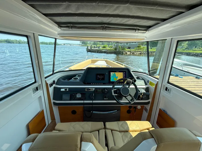 Willow Run Yacht Photos Pics Interior view of 2021 Axopar 28 CABIN boat with steering wheel and navigation system.