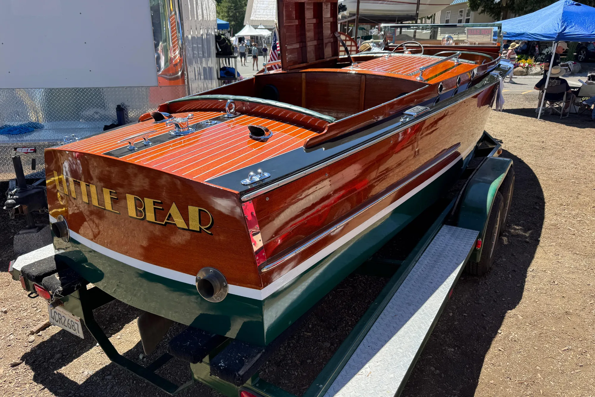 1987 Grand Craft Triple Cockpit Runabout "Little Bear" on trailer at outdoor event.