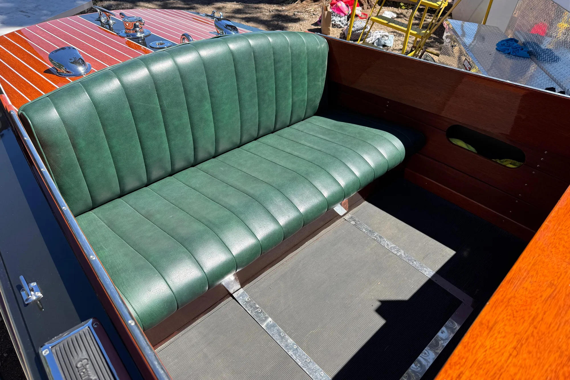 1987 Grand Craft Triple Cockpit Runabout with green leather seating and polished wood finish.