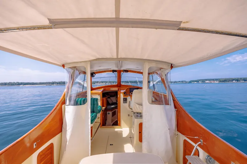 Genie Yacht Photos Pics 1999 Hinckley Picnic Boat interior with canopy, cruising on calm blue waters.