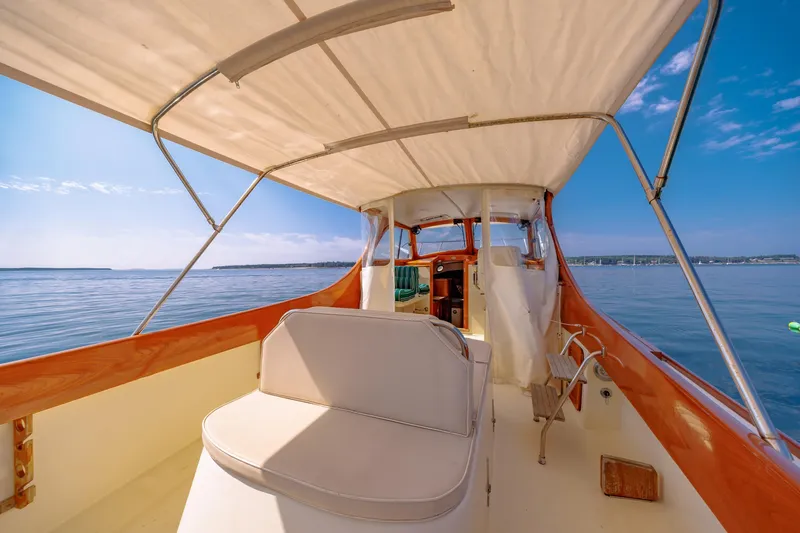 Genie Yacht Photos Pics 1999 Hinckley Picnic Boat interior with canopy, overlooking calm blue waters.