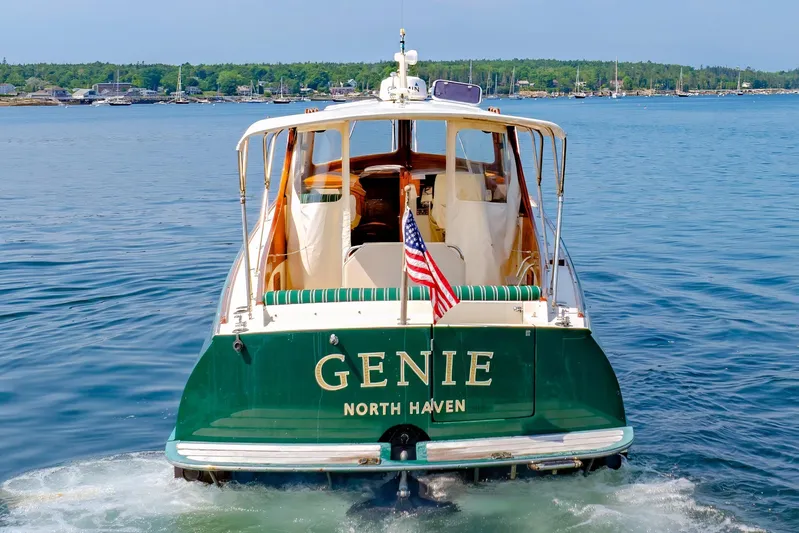 Genie Yacht Photos Pics 1999 Hinckley Picnic Boat "Genie" on water, displaying American flag, North Haven backdrop.