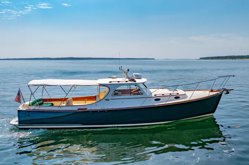 Genie Yacht Photos Pics 1999 Hinckley Picnic Boat cruising on calm waters under a clear blue sky.