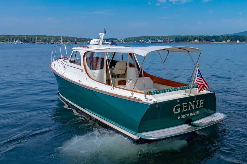 Genie Yacht Photos Pics 1999 Hinckley Picnic Boat cruising on calm waters with American flag.