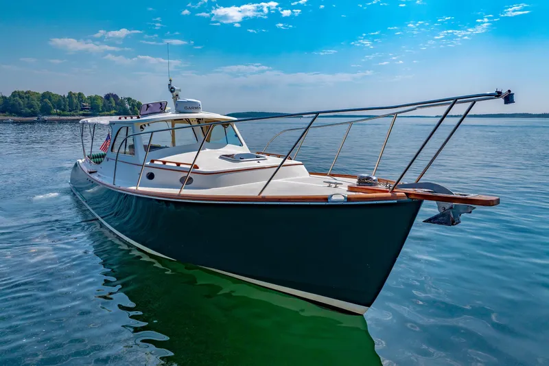 Genie Yacht Photos Pics 1999 Hinckley Picnic Boat cruising on calm waters under a clear blue sky.