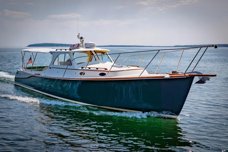 Genie Yacht Photos Pics 1999 Hinckley Picnic Boat cruising on open water under a clear sky.