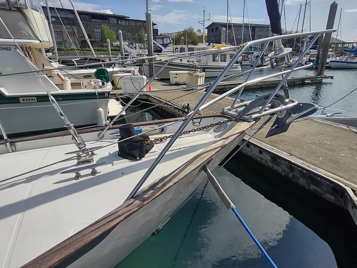 Wu Wei Yacht Photos Pics 1997 Pacific Seacraft 37 sailboat docked at a marina, featuring a sturdy bow and anchor.