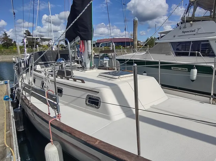 Wu Wei Yacht Photos Pics Sailboat docked at marina, Pacific Seacraft 37, 1997 model, under a partly cloudy sky.