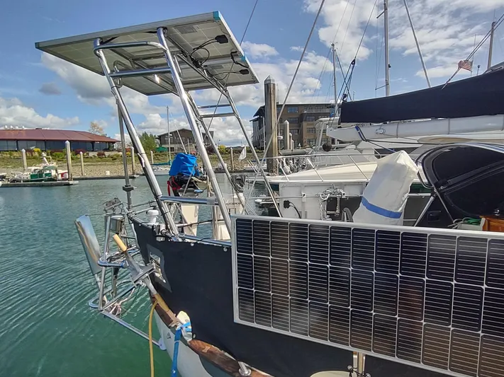 Wu Wei Yacht Photos Pics 1997 Pacific Seacraft 37 sailboat with solar panels docked in a marina.