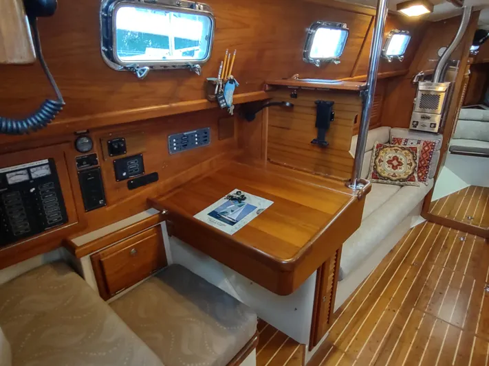 Wu Wei Yacht Photos Pics Interior of 1997 Pacific Seacraft 37 sailboat with wooden furnishings and navigation station.
