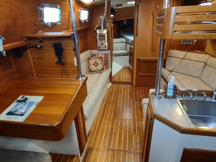 Wu Wei Yacht Photos Pics Interior of 1997 Pacific Seacraft 37 sailboat with wood finish and cozy seating area.