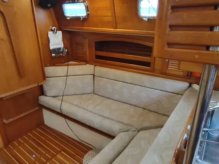 Wu Wei Yacht Photos Pics Interior of 1997 Pacific Seacraft 37 sailboat with cozy seating and wooden accents.