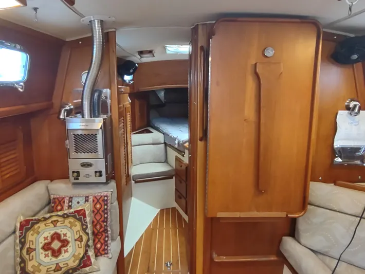 Wu Wei Yacht Photos Pics Interior of 1997 Pacific Seacraft 37 sailboat with wood finish and cozy seating area.