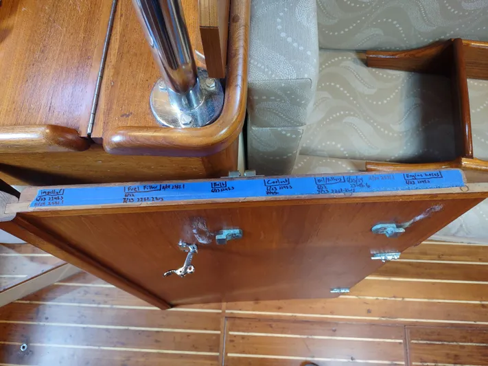 Wu Wei Yacht Photos Pics Interior of 1997 Pacific Seacraft 37 showing wooden cabinetry with handwritten notes on blue tape.