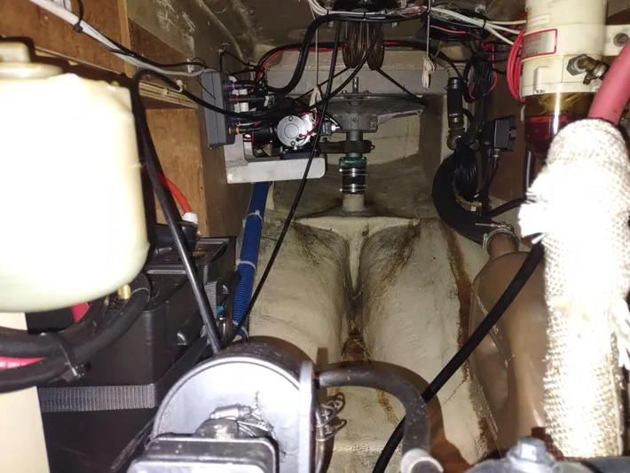 Wu Wei Yacht Photos Pics Engine compartment of a 1997 Pacific Seacraft 37 sailboat, showing mechanical components and wiring.