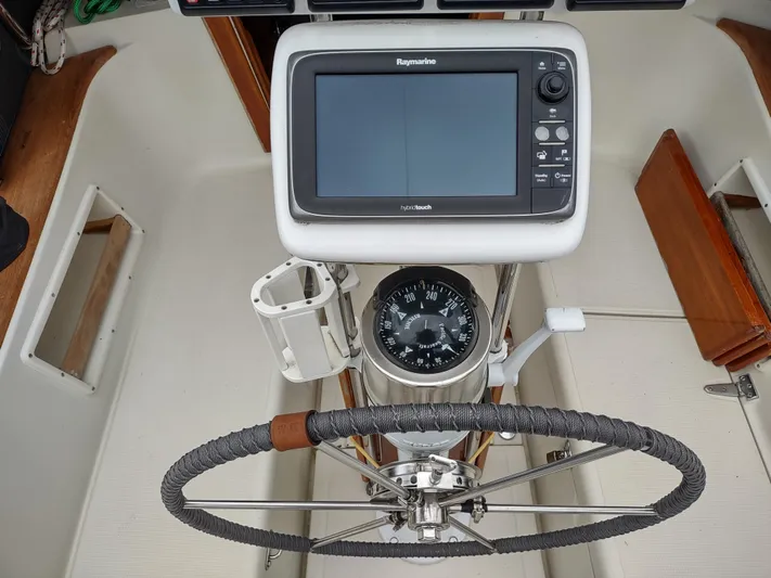 Wu Wei Yacht Photos Pics Cockpit of 1997 Pacific Seacraft 37 with navigation equipment and steering wheel.