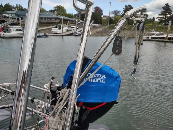 Wu Wei Yacht Photos Pics Sailboat with Honda Marine engine cover, docked in a marina. Pacific Seacraft 37, 1997 model.