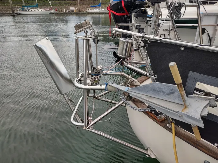Wu Wei Yacht Photos Pics Sailboat stern with wind vane and anchor, Pacific Seacraft 37, 1997 model, docked in marina.