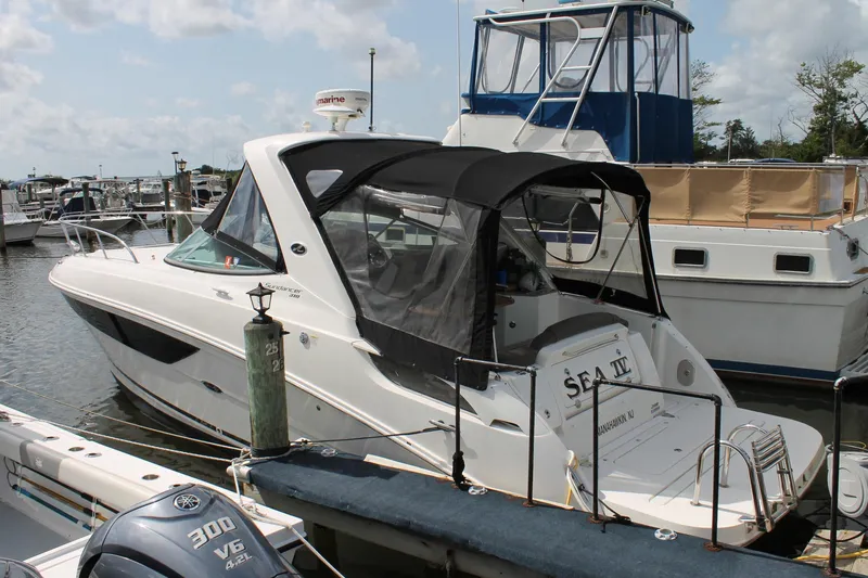  Yacht Photos Pics 2015 Sea Ray Sundancer 310 docked at marina, featuring sleek design and black canopy.