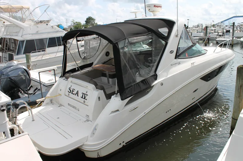  Yacht Photos Pics 2015 Sea Ray Sundancer 310 docked at marina, featuring sleek design and black canopy.
