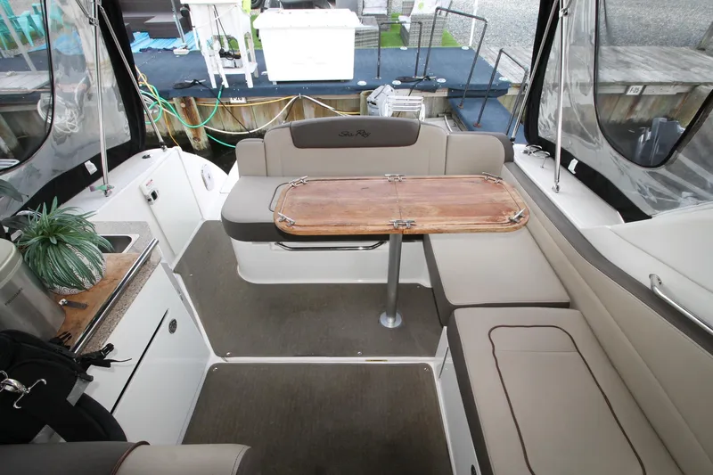  Yacht Photos Pics Interior of 2015 Sea Ray Sundancer 310 with seating and wooden table.