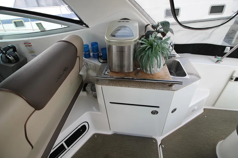  Yacht Photos Pics Interior of 2015 Sea Ray Sundancer 310 with kitchenette and seating area.