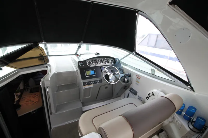  Yacht Photos Pics 2015 Sea Ray Sundancer 310 helm with steering wheel, gauges, and navigation equipment.