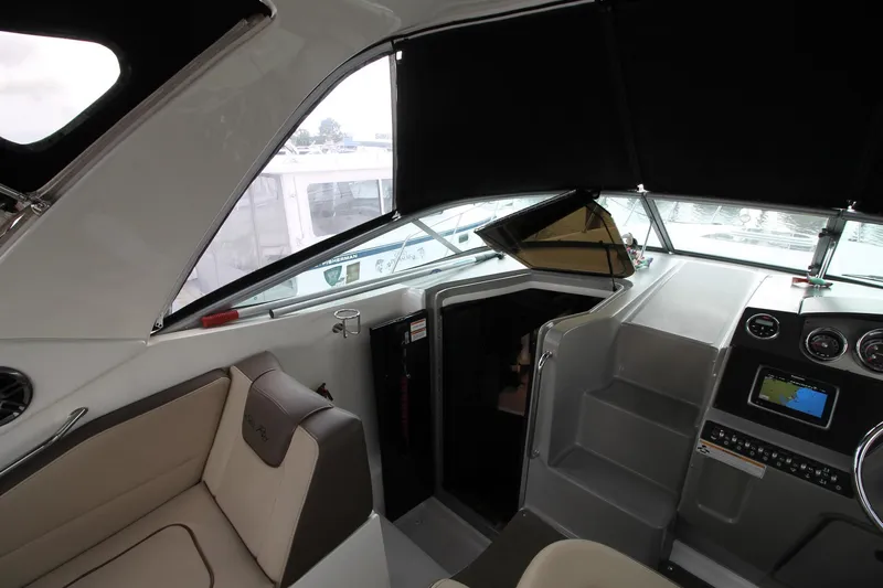  Yacht Photos Pics Interior view of 2015 Sea Ray Sundancer 310 boat cockpit with seating and navigation controls.