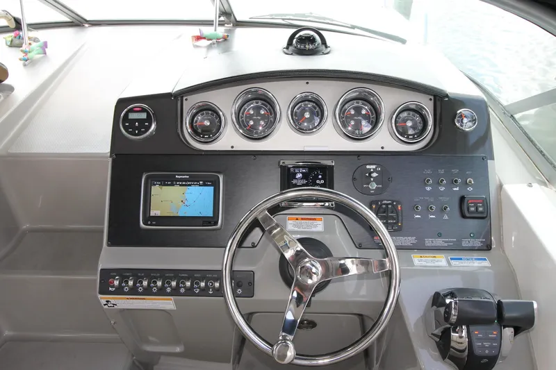  Yacht Photos Pics 2015 Sea Ray Sundancer 310 helm with navigation controls and gauges.