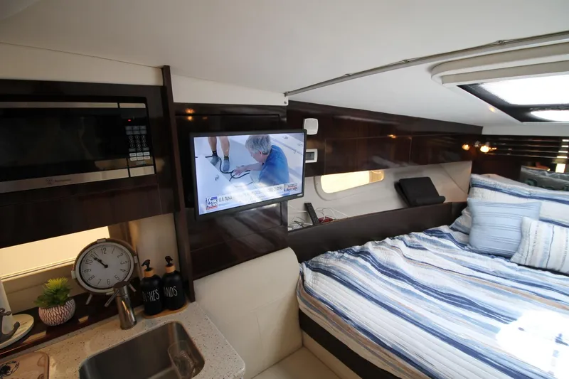  Yacht Photos Pics Interior of 2015 Sea Ray Sundancer 310 with bed, TV, and kitchenette amenities.