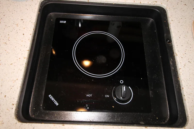  Yacht Photos Pics Kenyon stove on 2015 Sea Ray Sundancer 310 yacht, featuring sleek black design.