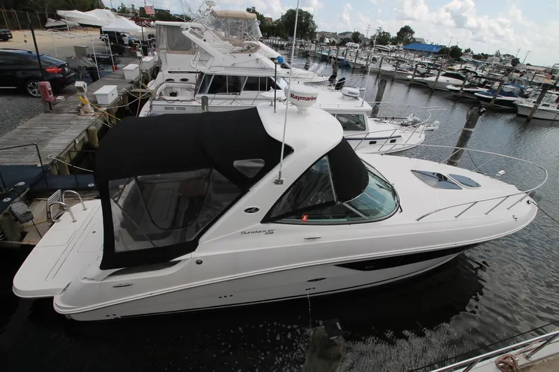  Yacht Photos Pics 2015 Sea Ray Sundancer 310 docked at a marina, featuring sleek design and black canopy.