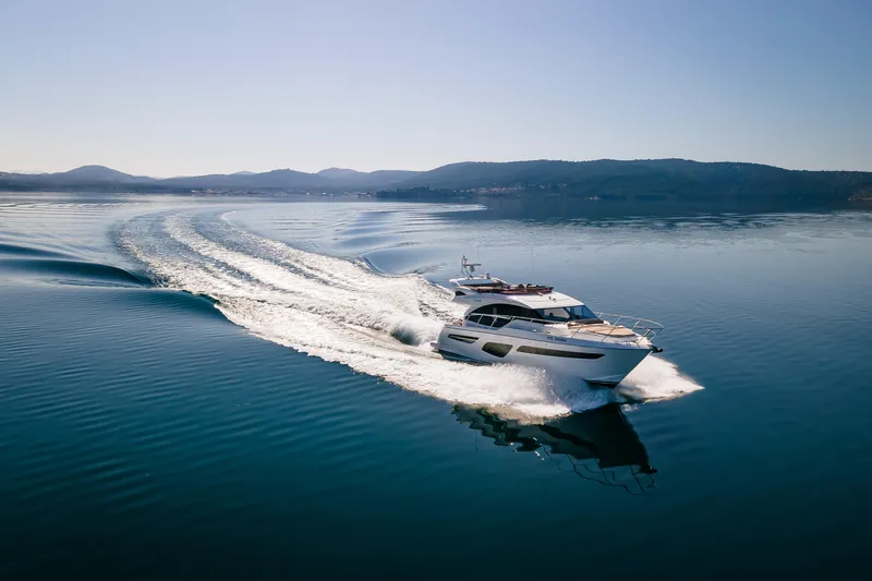 Whiskey Yacht Photos Pics Luxury Princess F55 yacht cruising on calm waters, 2021 model.