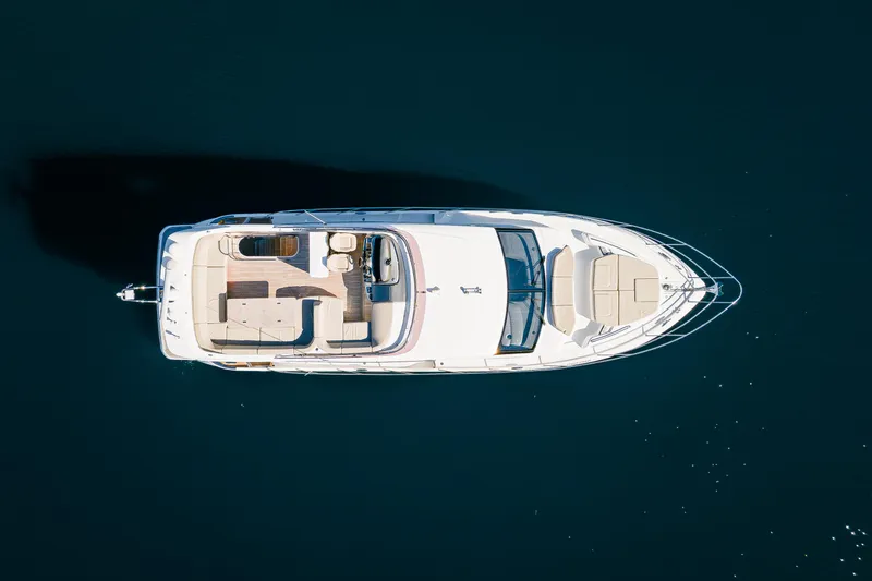 Whiskey Yacht Photos Pics Aerial view of 2021 Princess F55 yacht on calm water.