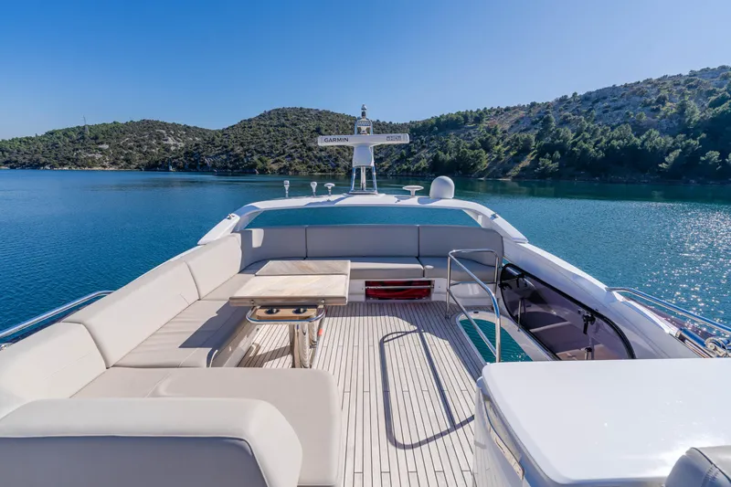 Whiskey Yacht Photos Pics Luxurious 2021 Princess F55 yacht deck with scenic water and hillside views.