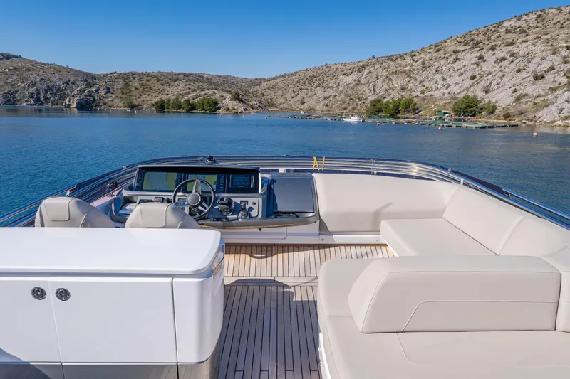 Whiskey Yacht Photos Pics Luxurious 2021 Princess F55 yacht interior with scenic water and mountain backdrop.