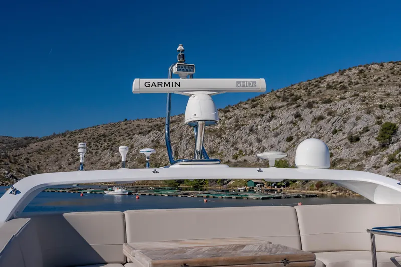 Whiskey Yacht Photos Pics Luxury Princess F55 yacht with Garmin radar, 2021 model, cruising near rocky coastline.