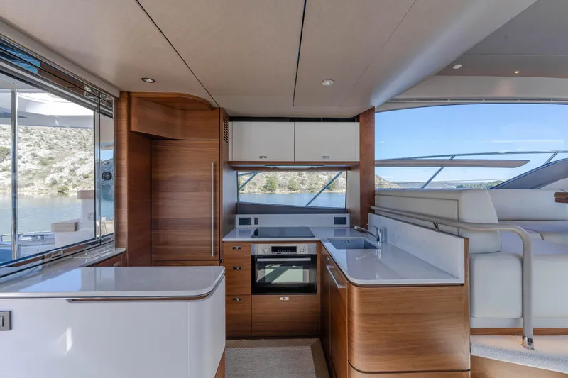 Whiskey Yacht Photos Pics Luxurious 2021 Princess F55 yacht interior with modern kitchen and scenic water view.